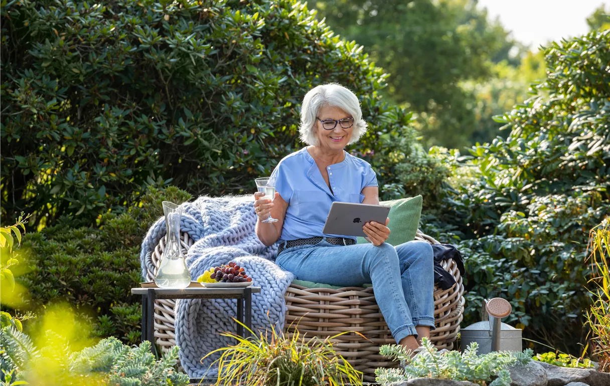 Gartenfreizeit - Frau mit Tablet im Garten 